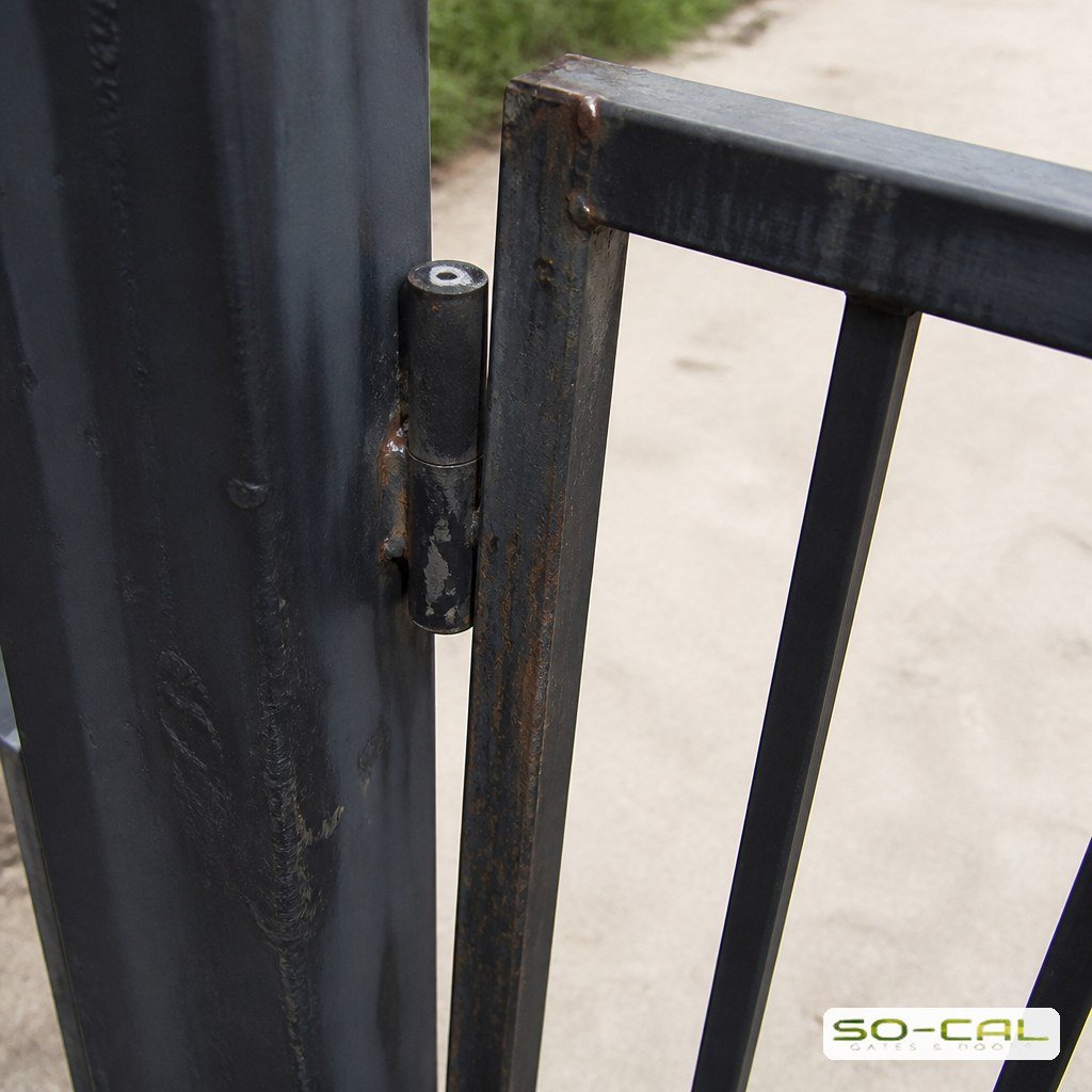 Worn hinge causing a metal gate to sag against its post